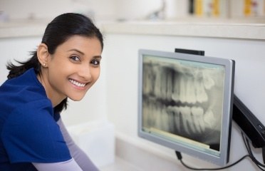 Dental assistant looking at x-rays during radiography training