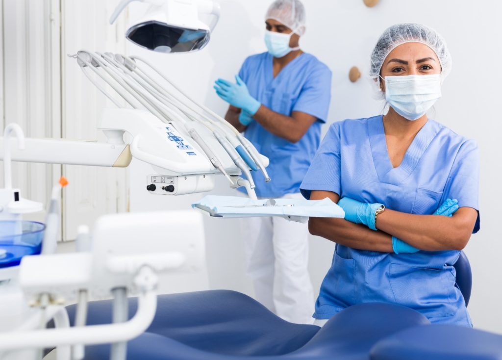 Closeup of dental assistant smiling while wearing PPE