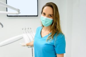 Smiling masked dental assistant in Worcester