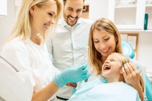 pediatric dental assistant working with smiling child