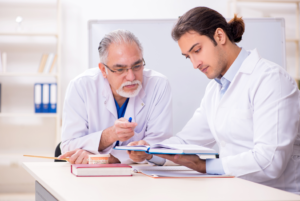 a dental assistant instructor working with a student