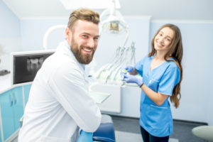 a dental hygiene student and dentist smiling 