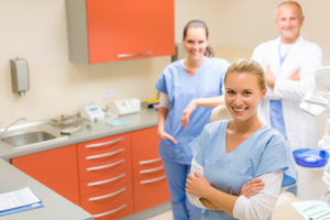 a dental assistant student smiling in a classroom